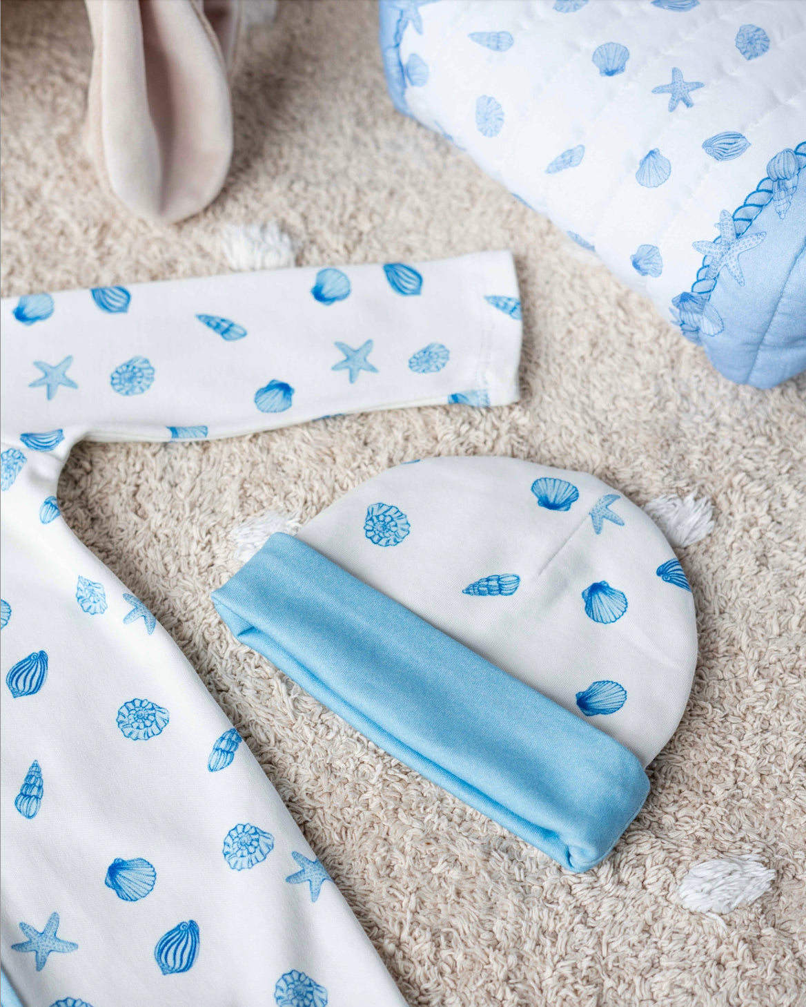 Sea Shell patterned newborn hat and bib set, ideal for daily baby essentials