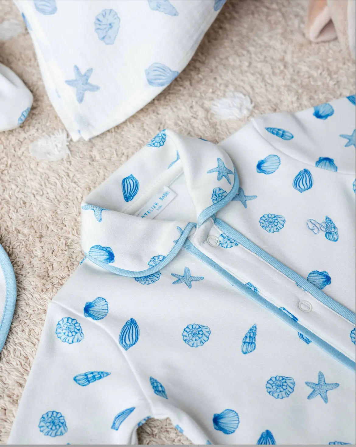 Close-up of Sea Shell baby onesie made from breathable 100% cotton fabric