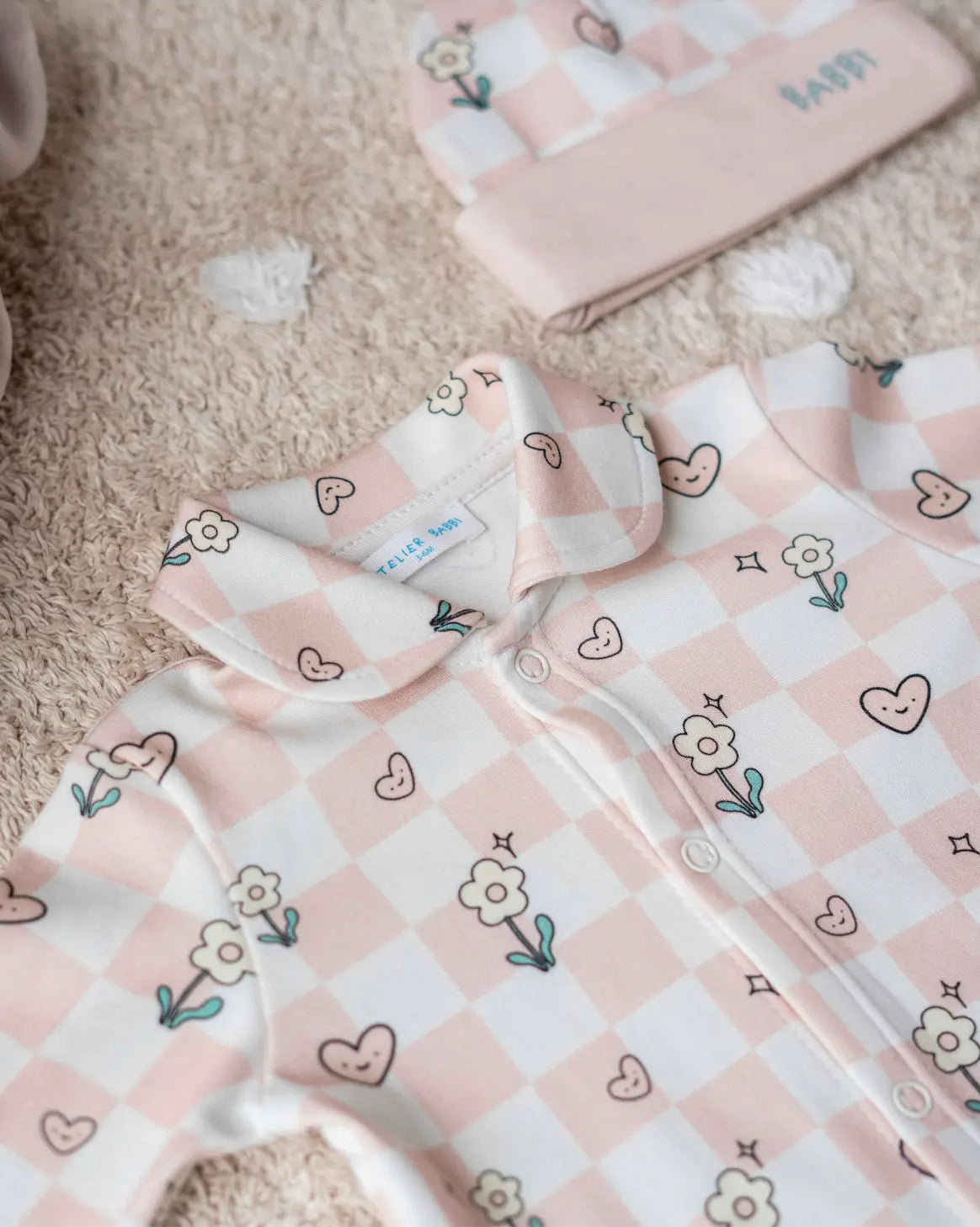 Close-up of soft cotton checkered baby jumpsuit designed for 0–3 months old infants