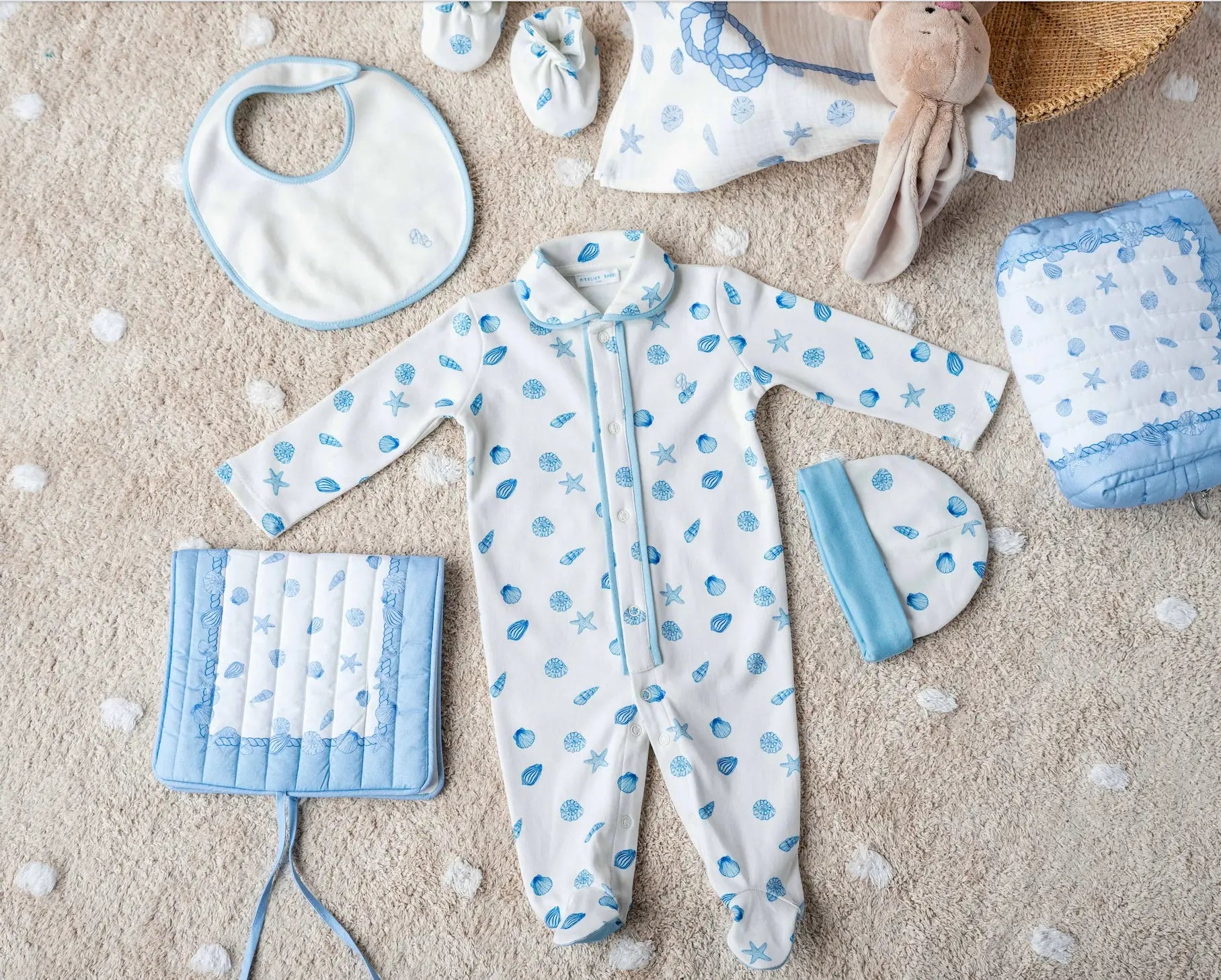 Flat lay of Sea Shell organic baby outfit set with natural colors and soft texture