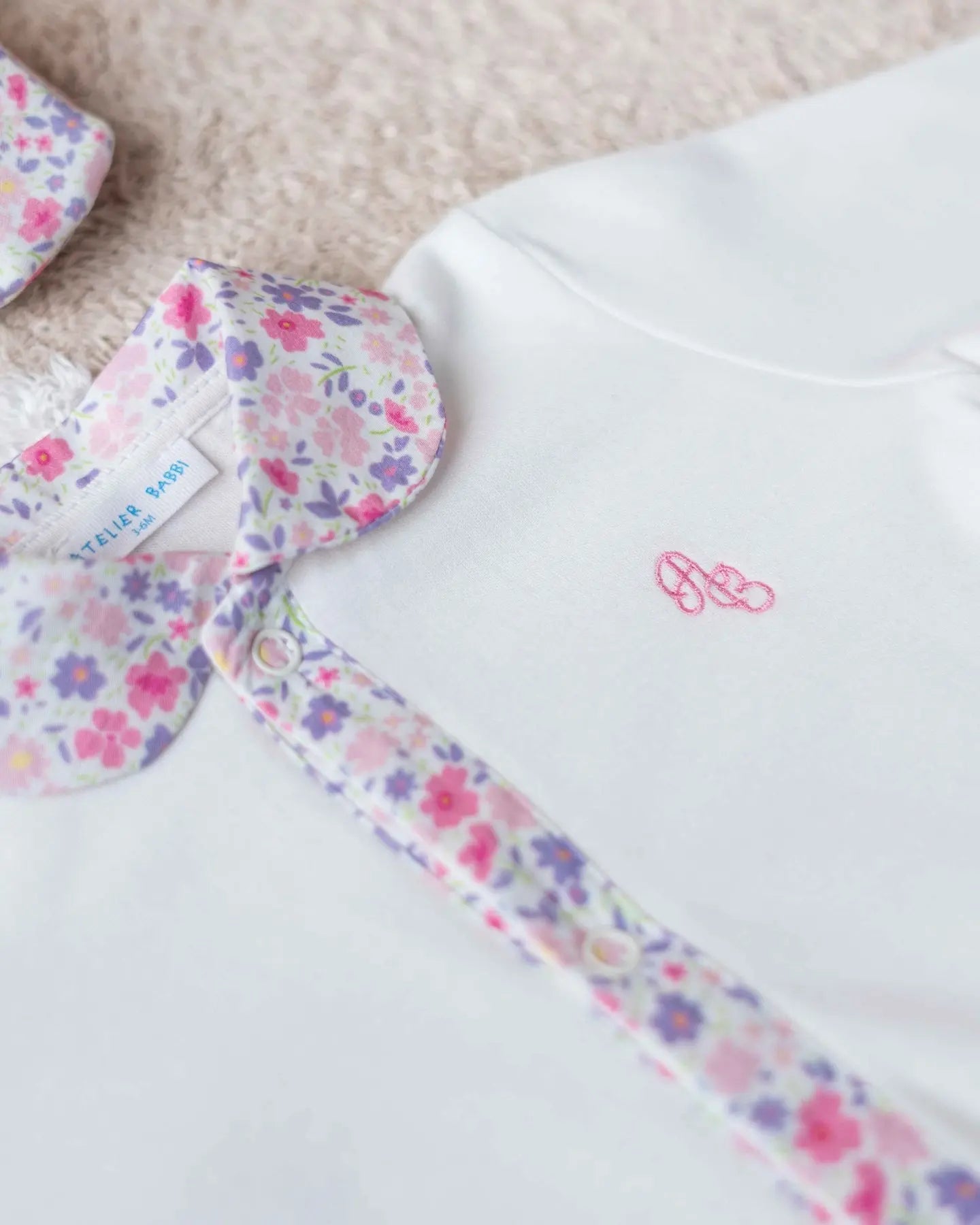 Pink baby footed onesie with tiny floral print