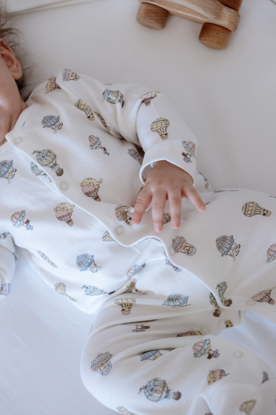 Close-up of hot air balloon print on soft cotton baby jumpsuit for 0–3 months