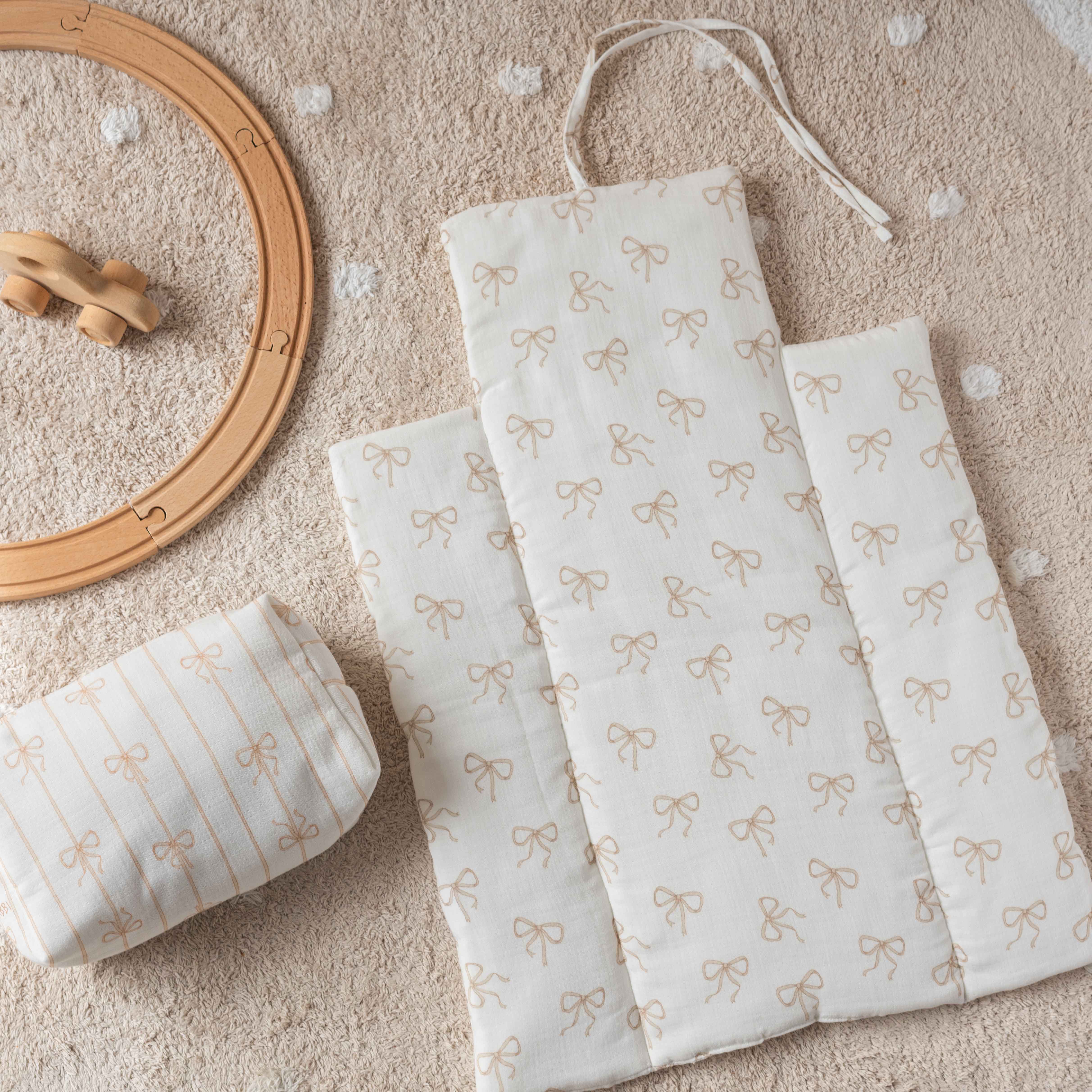 Beige baby diaper changing mat and pouch set with delicate ribbon pattern – Atelier Babbi essentials