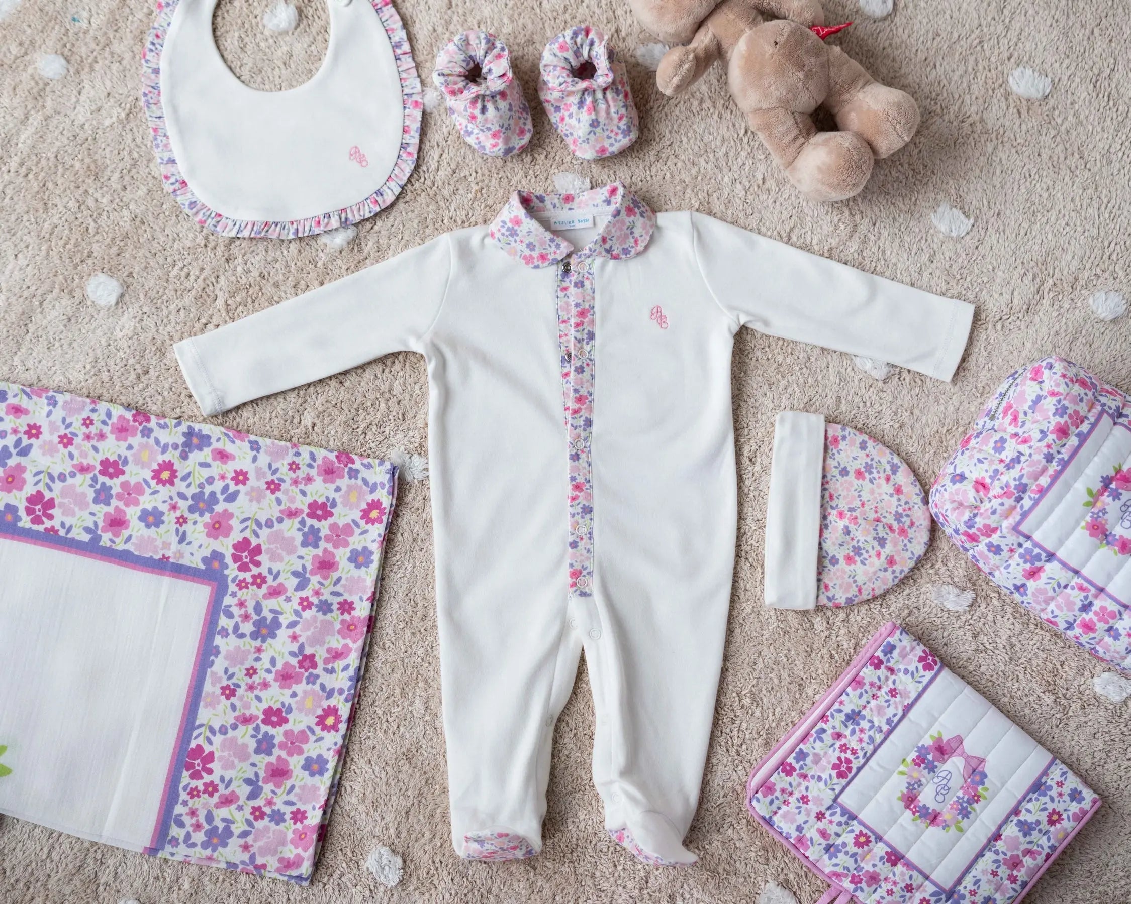 Soft newborn outfit featuring tiny pink blossoms