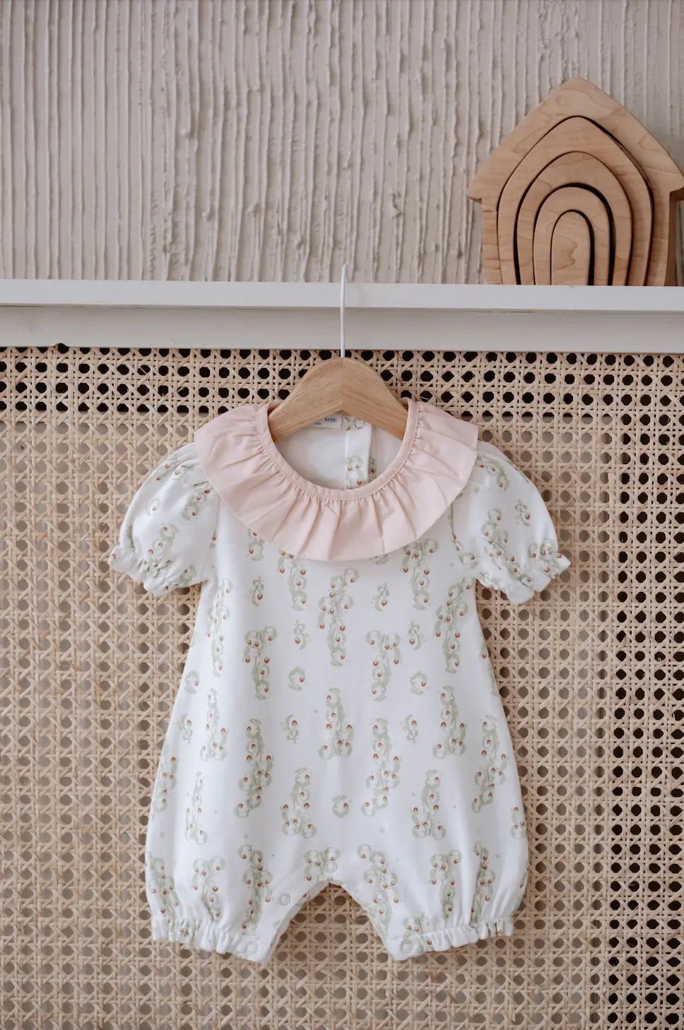 Soft cotton baby romper featuring hand-stitched strawberry motif – perfect for newborns