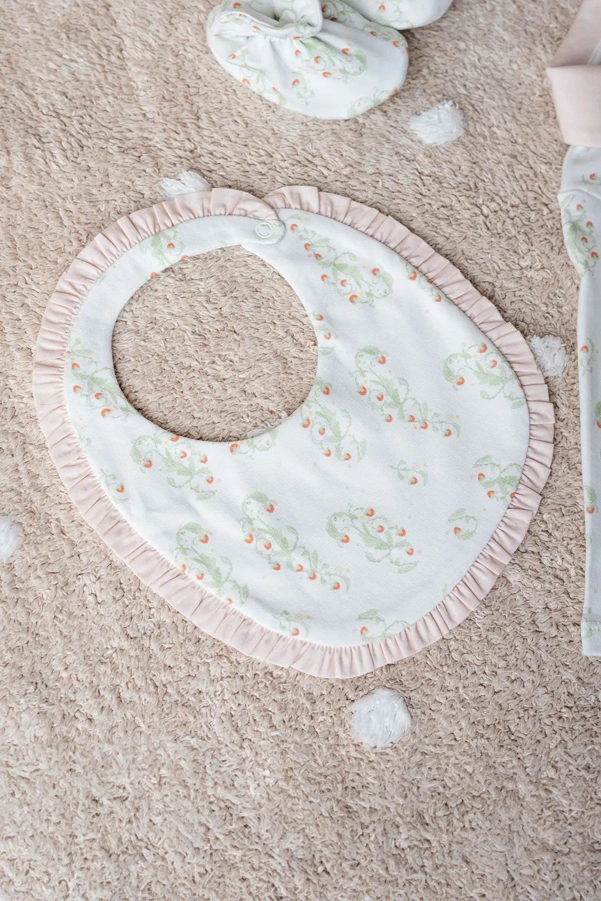 Strawberry baby bib made from 100% cotton, perfect for newborns and gentle on delicate skin.