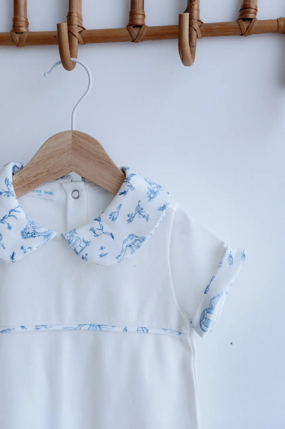 Close-up of delicate blue print on Atelier Babbi Toile de Jouy romper for babies