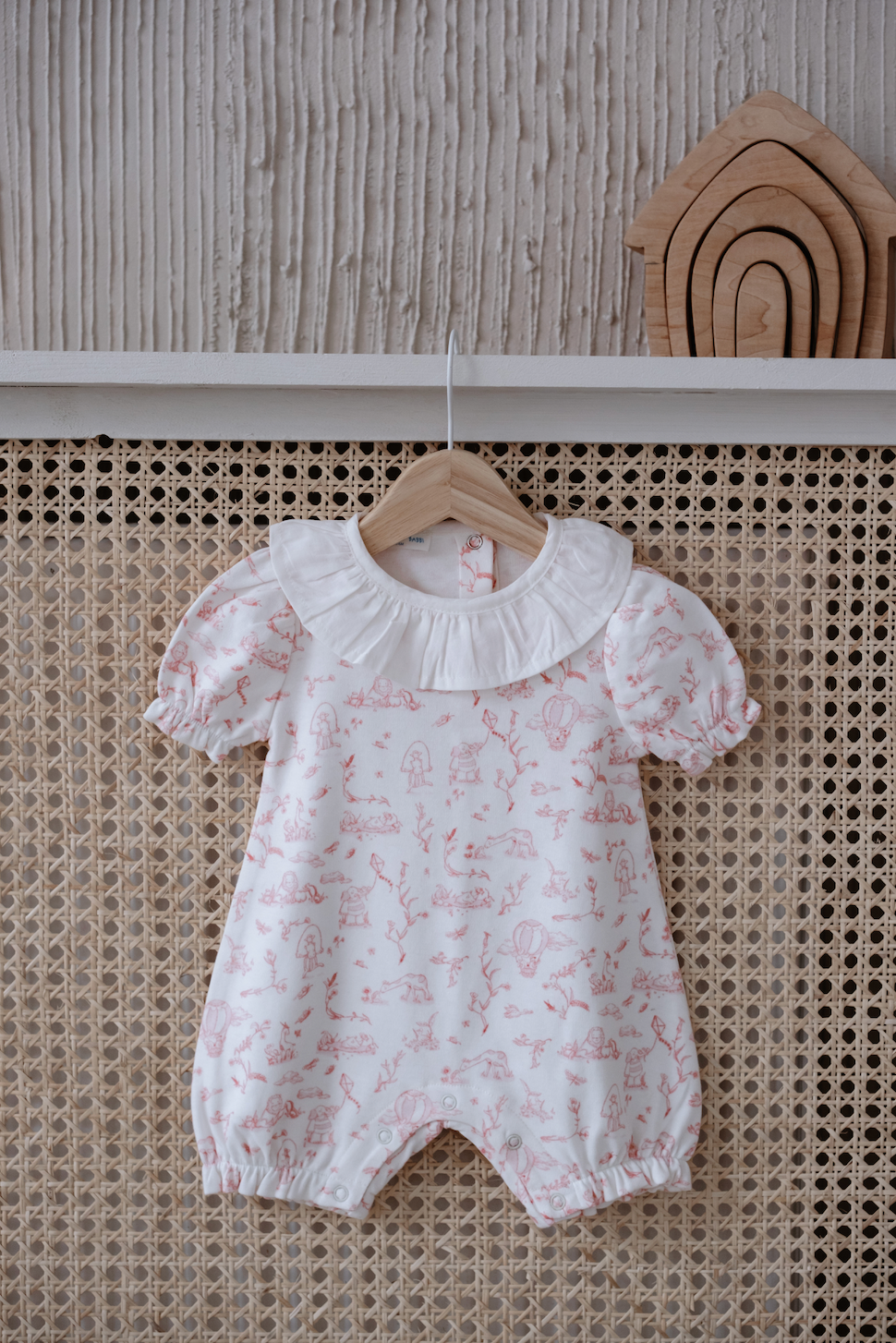 Soft cotton baby outfit with hand-illustrated countryside scene