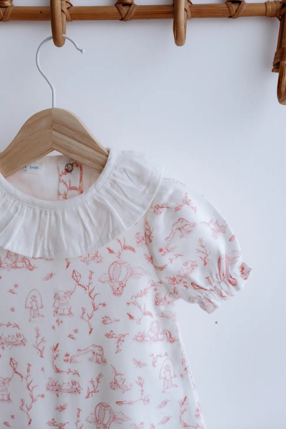 French-inspired romper with elegant storybook-style design