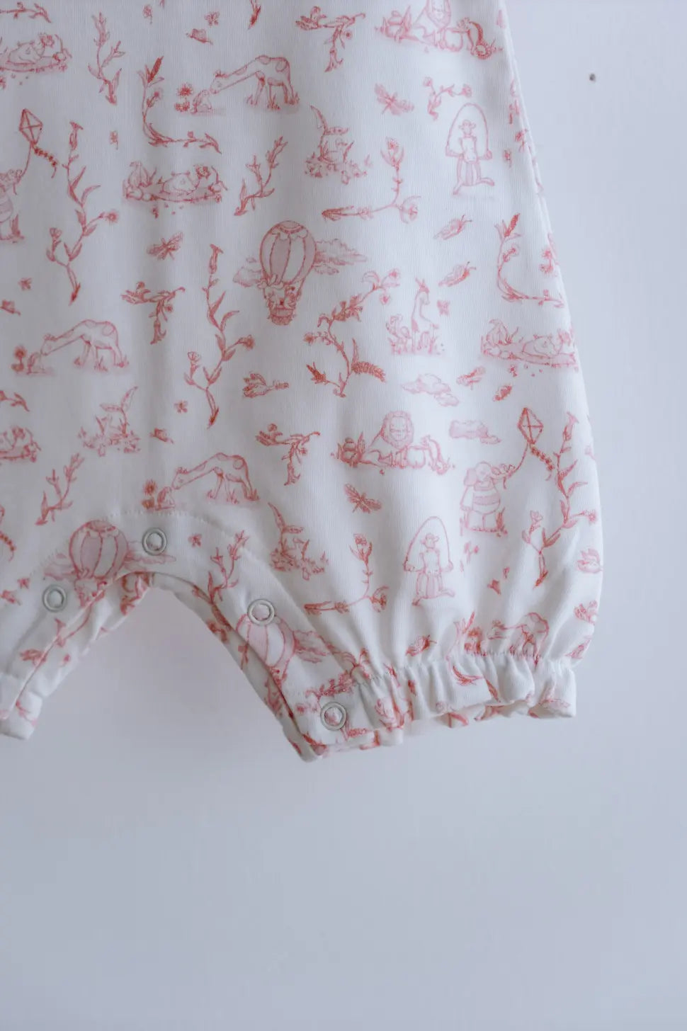 Newborn romper featuring heritage-style print for timeless baby looks