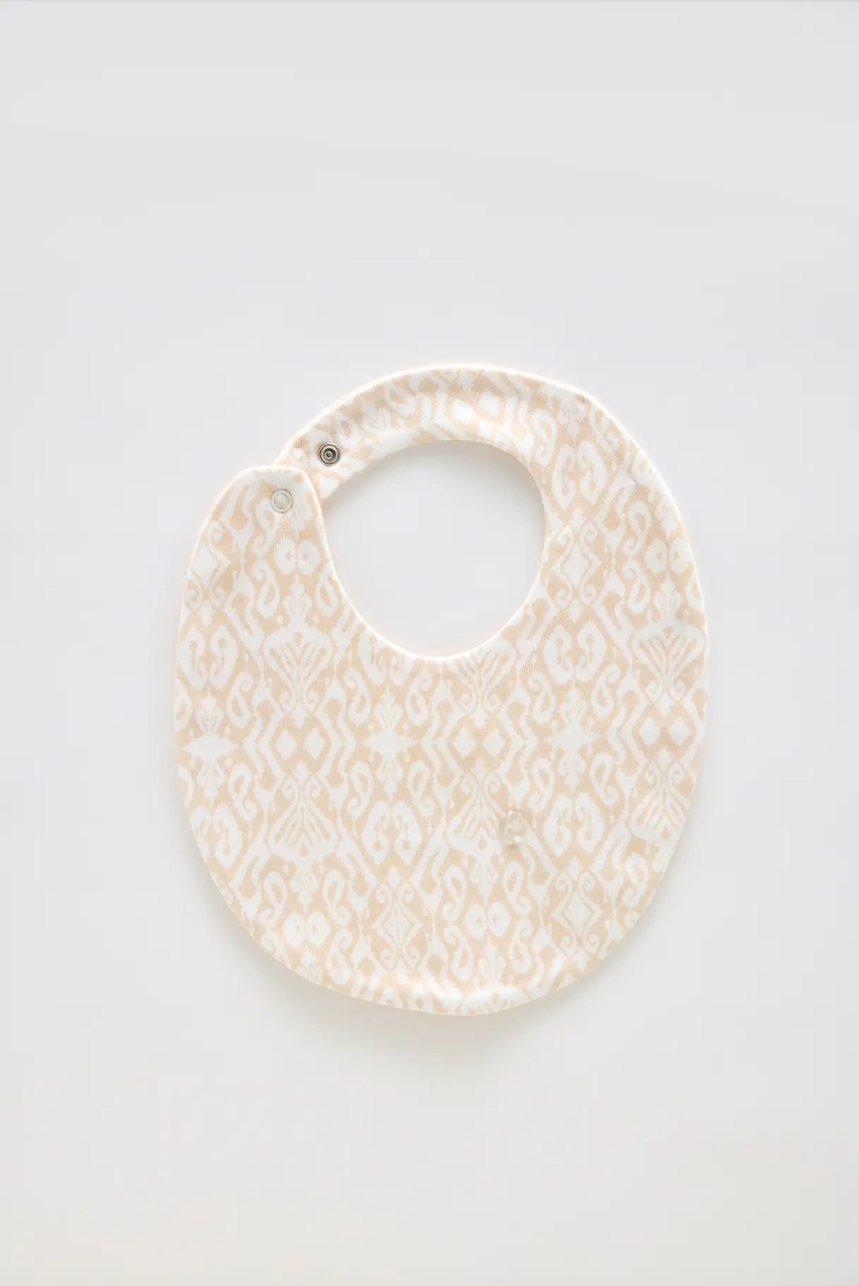Ikat/Beige baby bib made from 100% cotton, perfect for newborns and gentle on delicate skin.