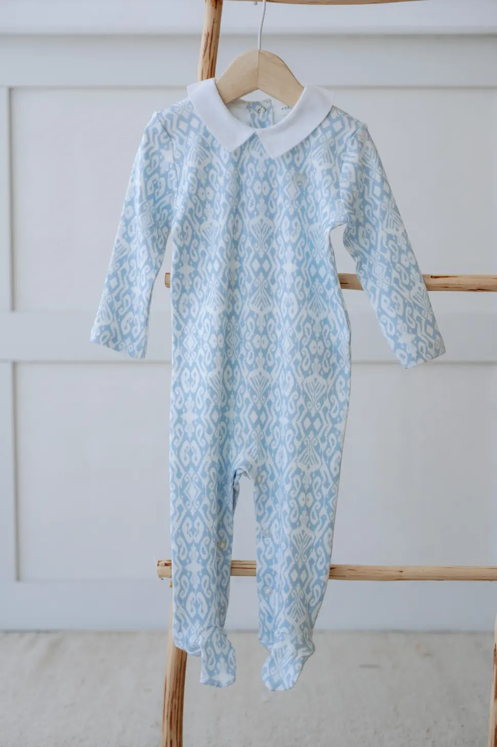Ikat pattern blue baby footed onesie