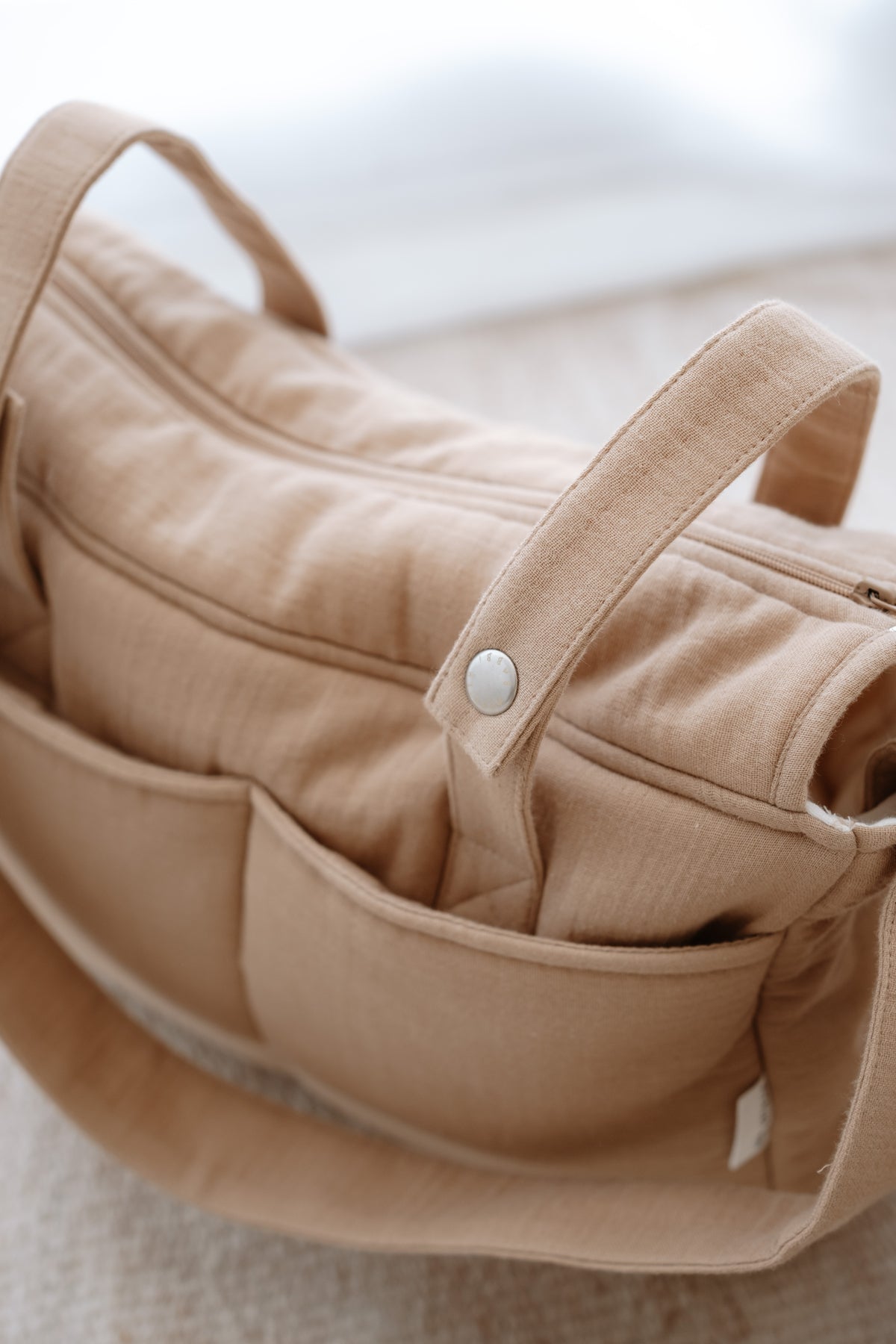 Close-up of soft muslin fabric texture on Atelier Babbi diaper bag
