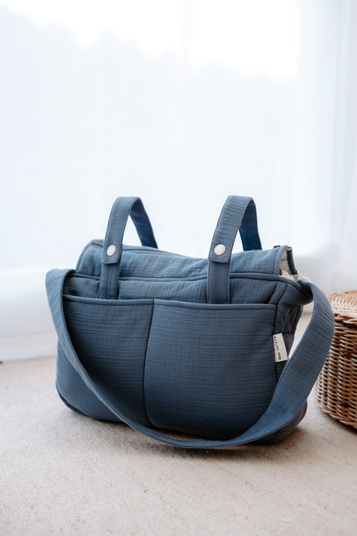 Muslin mommy bag in ribbon blue color displayed on a white background