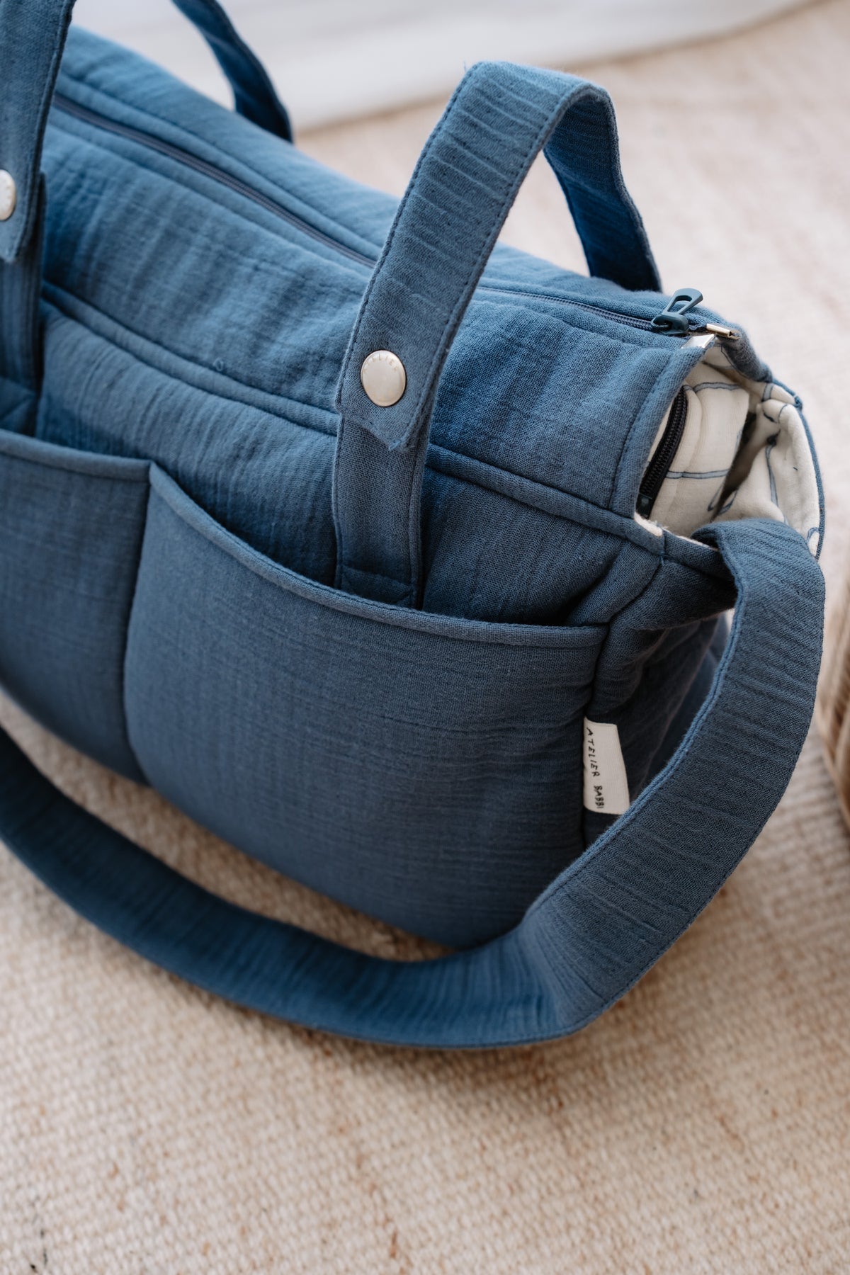 Elegant cotton diaper bag in blue with ribbon detail – perfect for moms