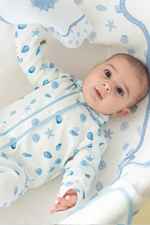 Neutral baby sleeper with seashell illustrations