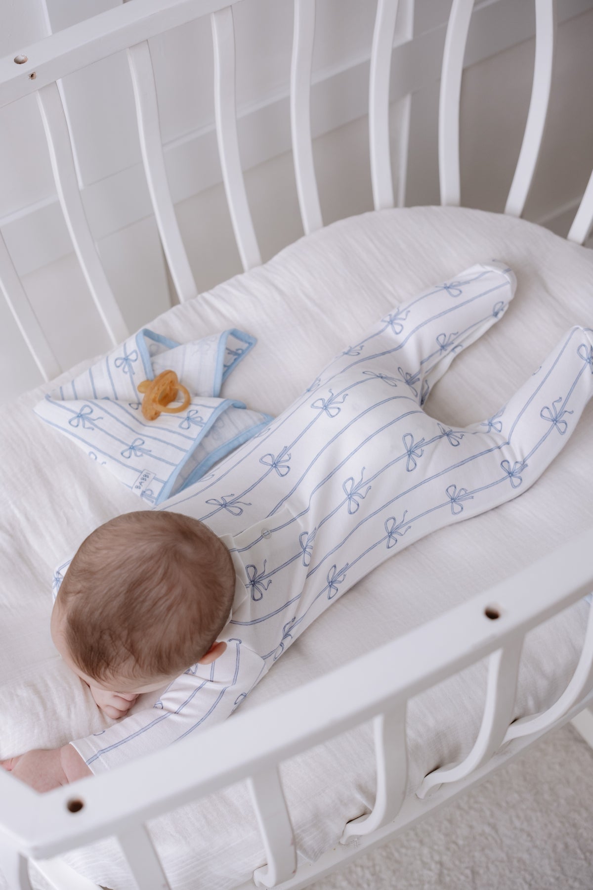 Baby sleeper with blue ribbon detail