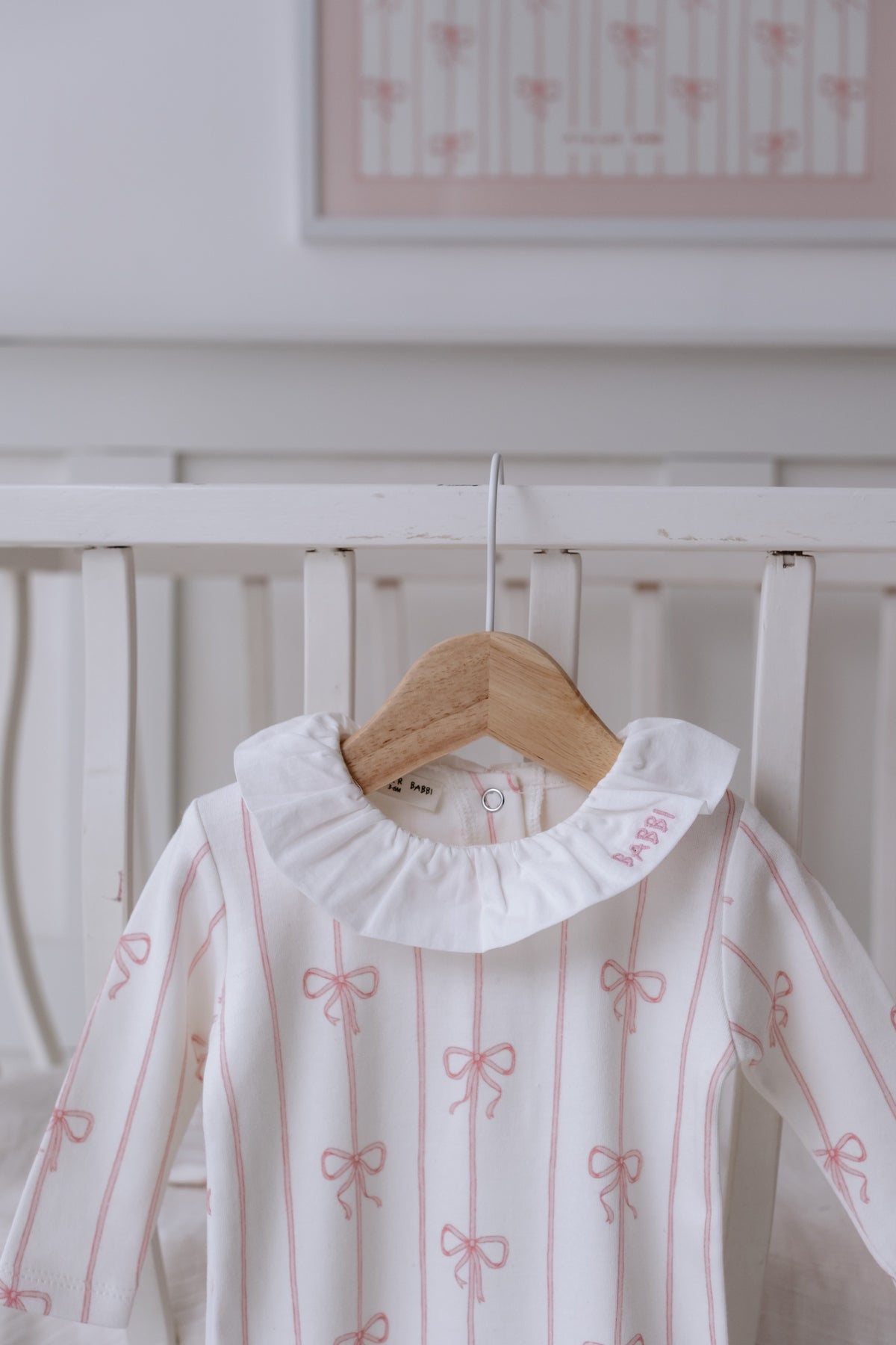 Close-up of pink ribbon footed onesie fabric texture