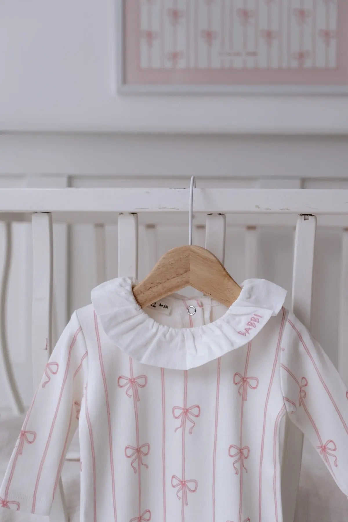 Close-up of pink ribbon footed onesie fabric texture
