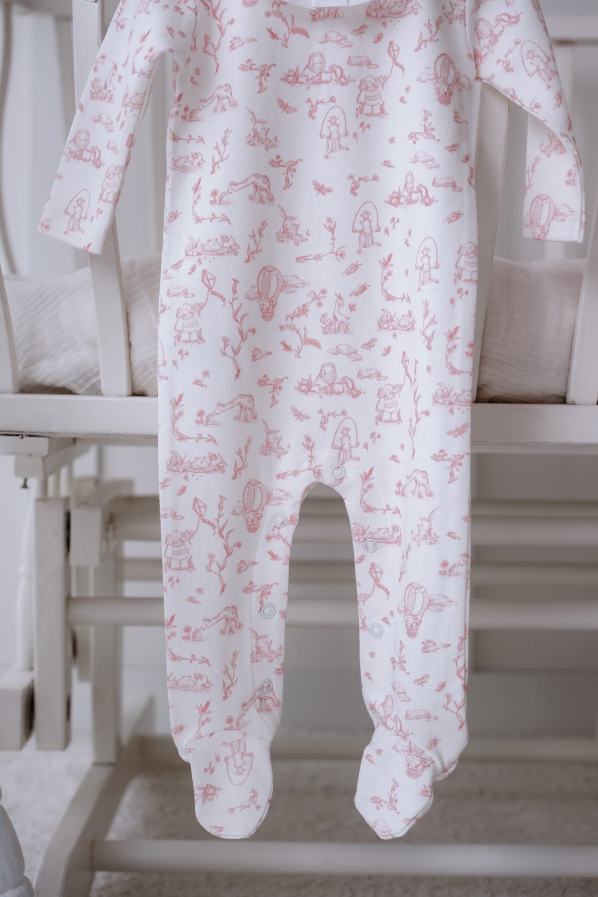 Soft pink baby sleeper with French pattern