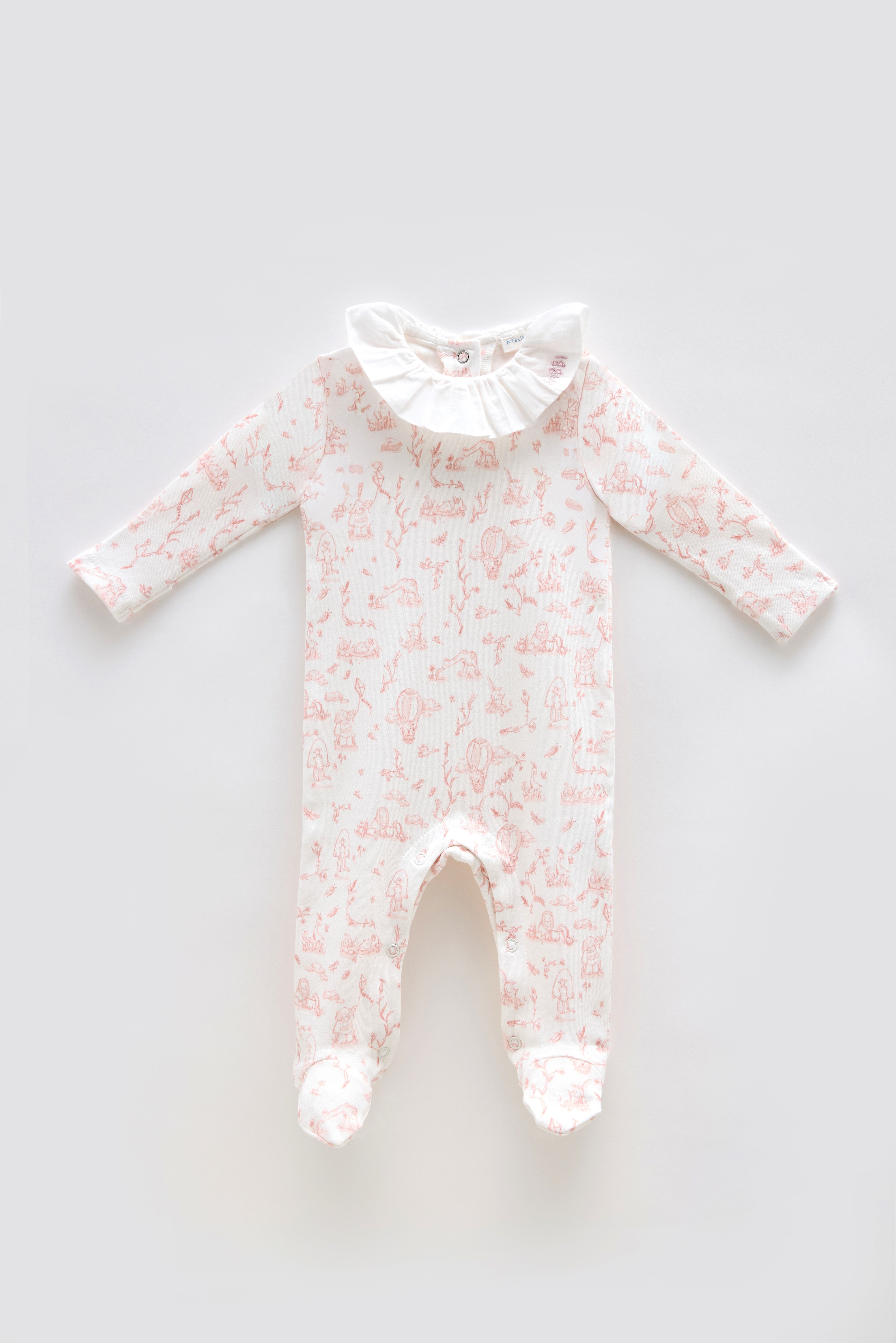 Baby onesie with pink toile pattern on a light gray background