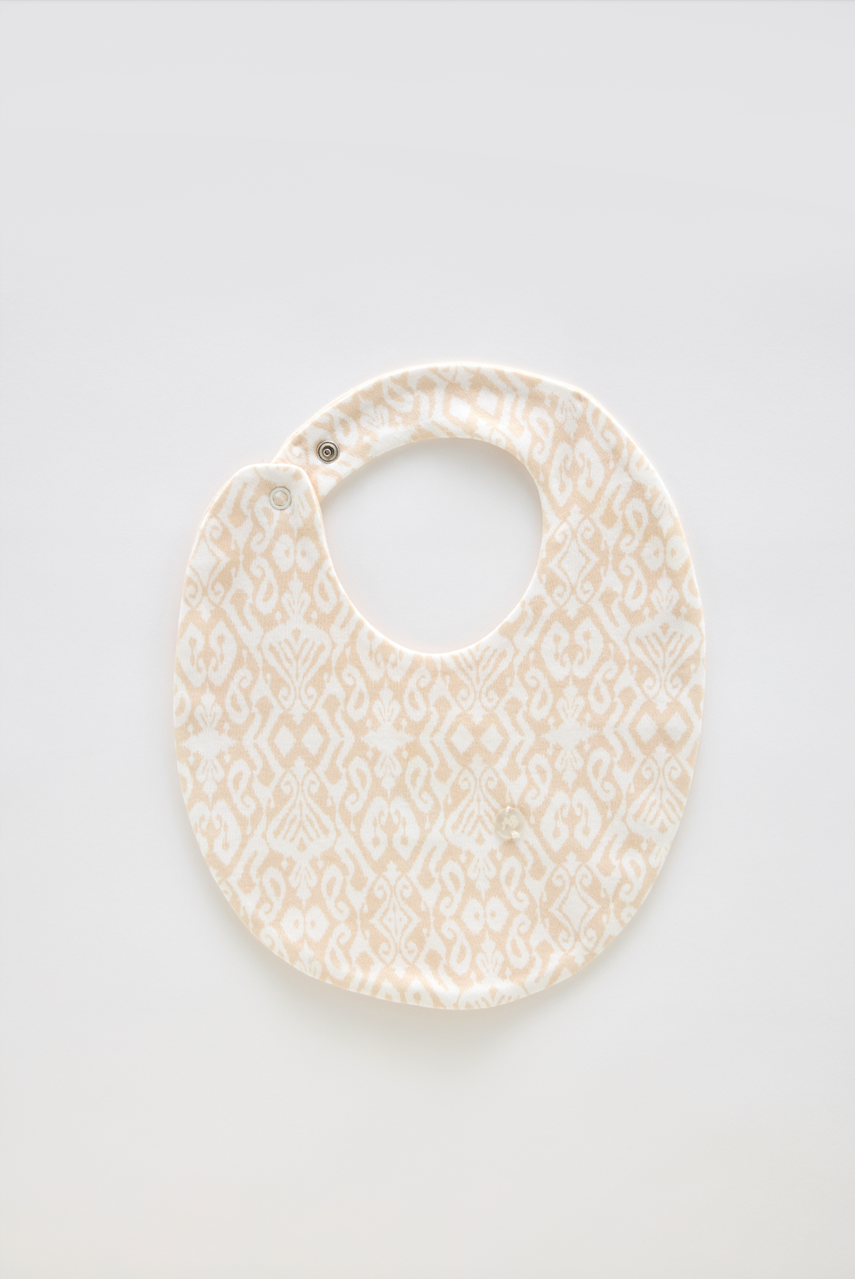 Ikat/Beige baby bib made from 100% cotton, perfect for newborns and gentle on delicate skin.